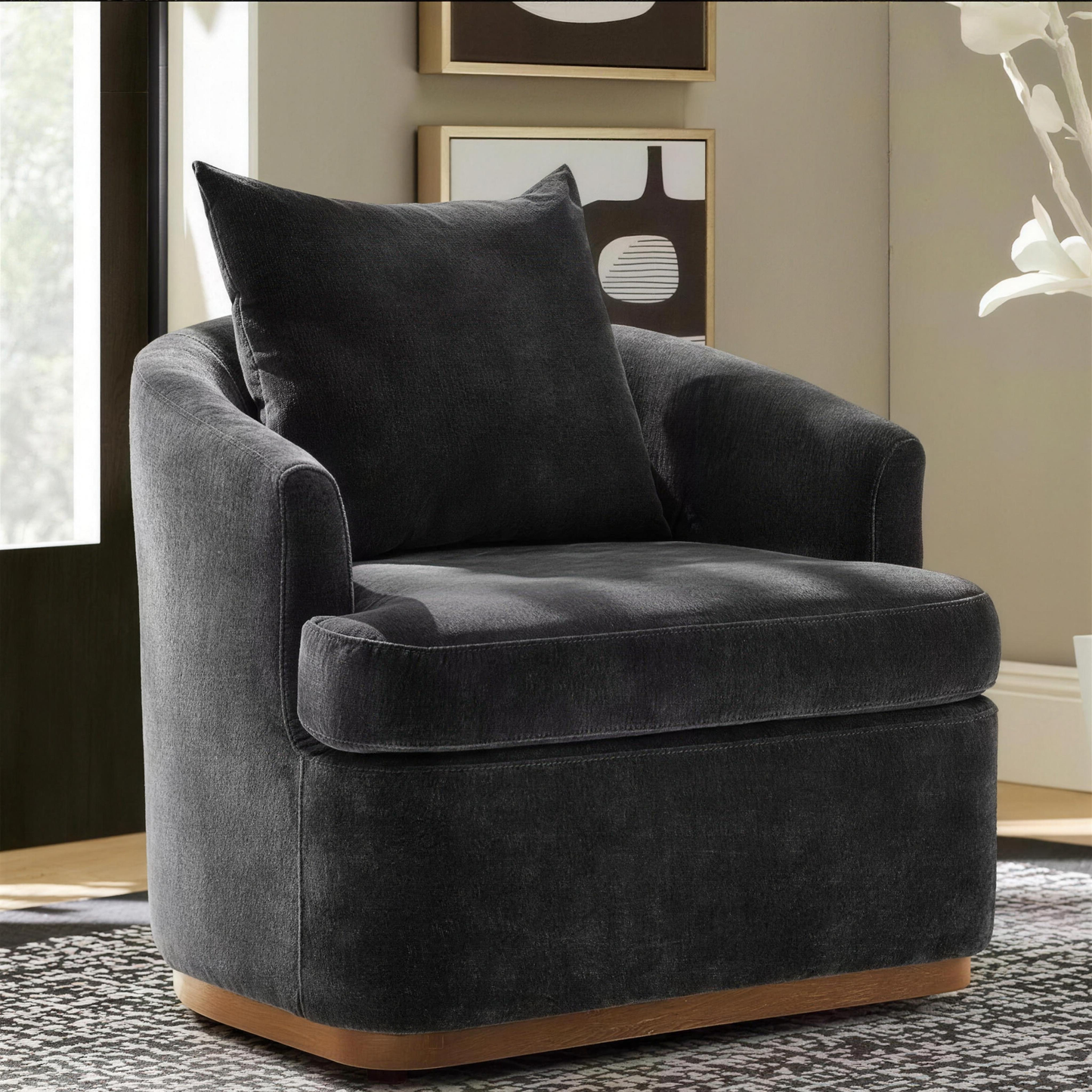 Ridley black chenille swivel accent chair with a matching pillow on a solid wood base