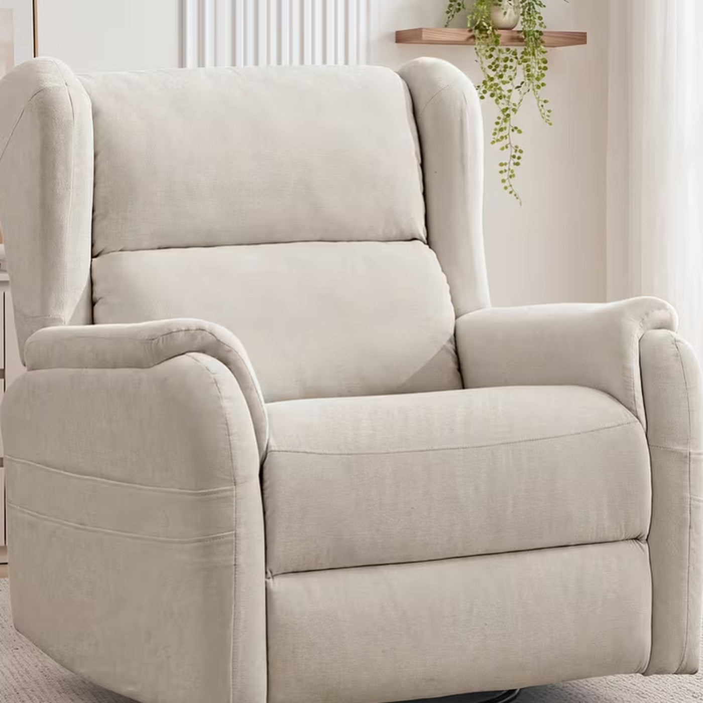 Wren cream chenille wingback swivel rocker recliner in a bright living room