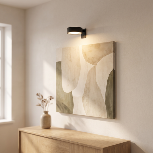 Orla cordless picture light above an abstract painting