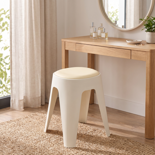 Pia round cushioned stool in white beside a wooden vanity desk