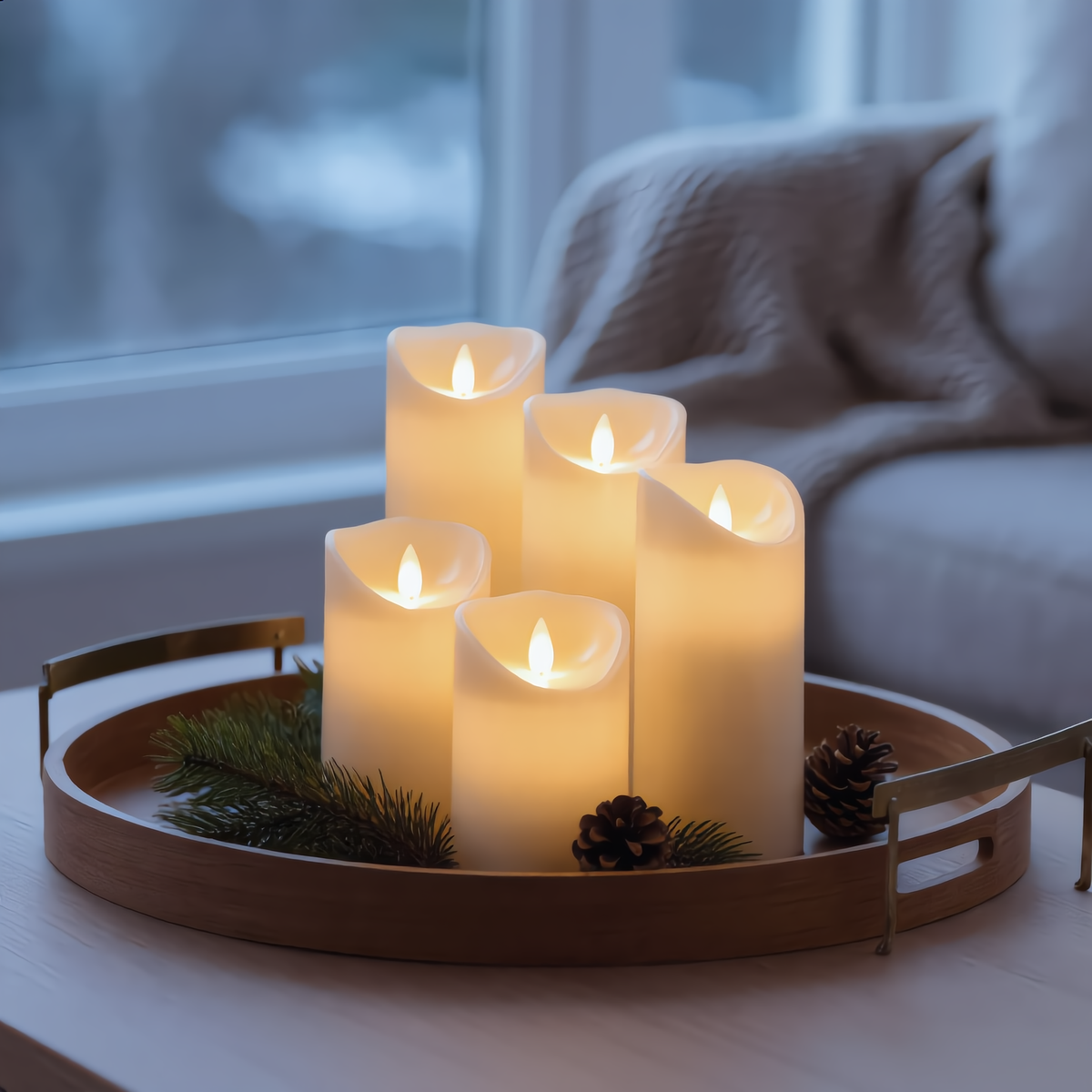 Wynn flameless LED pillar candles on a wooden tray in a cozy living room