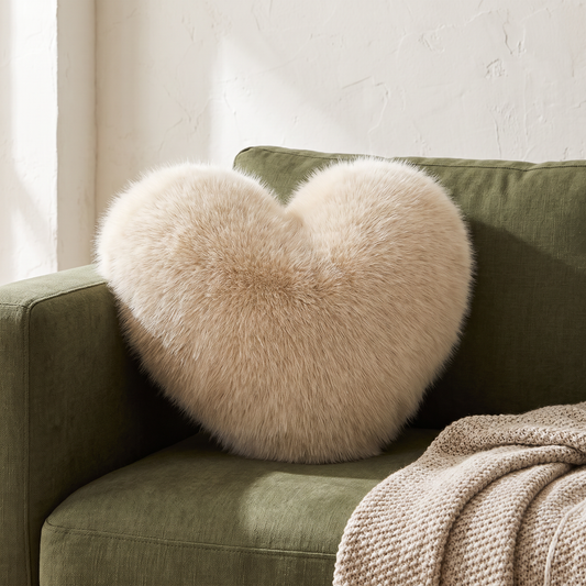 Coco Faux Fur Heart Pillow in Beige on an olive sofa