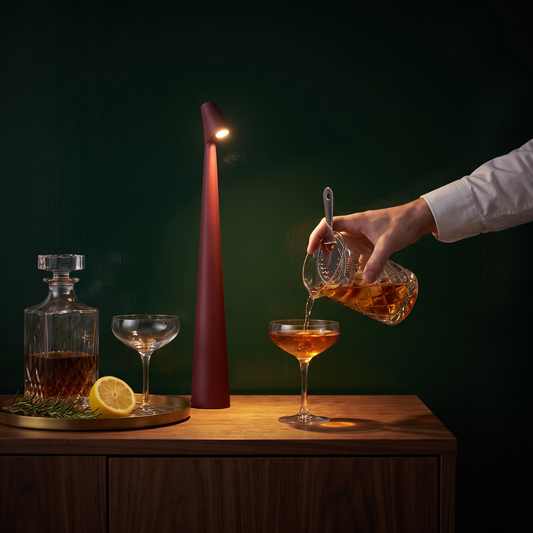 Lark cordless table lamp in red, rechargeable LED lamp glowing on a home bar at night