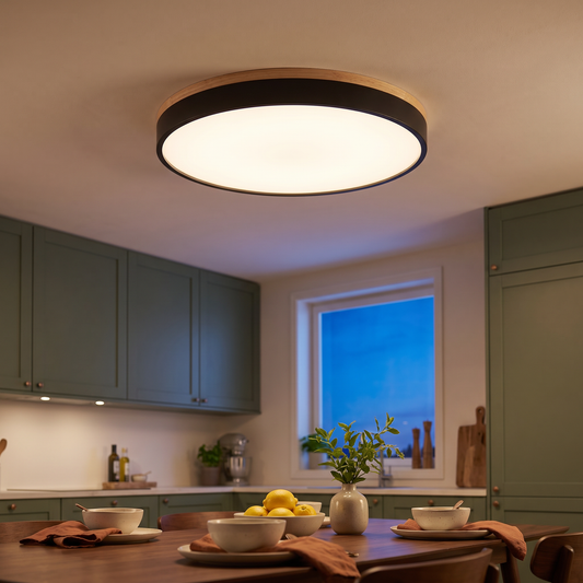 Saga wood trim flush mount ceiling light in black, round LED fixture over a dining table