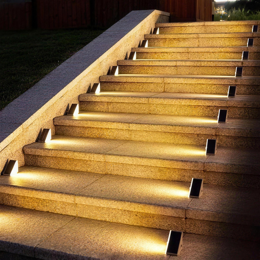 Ashby solar stair lights glowing warm white on granite outdoor steps at night