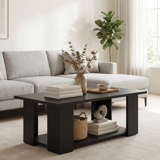 Halden black two tier coffee table with an open lower storage shelf in front of a pale sectional