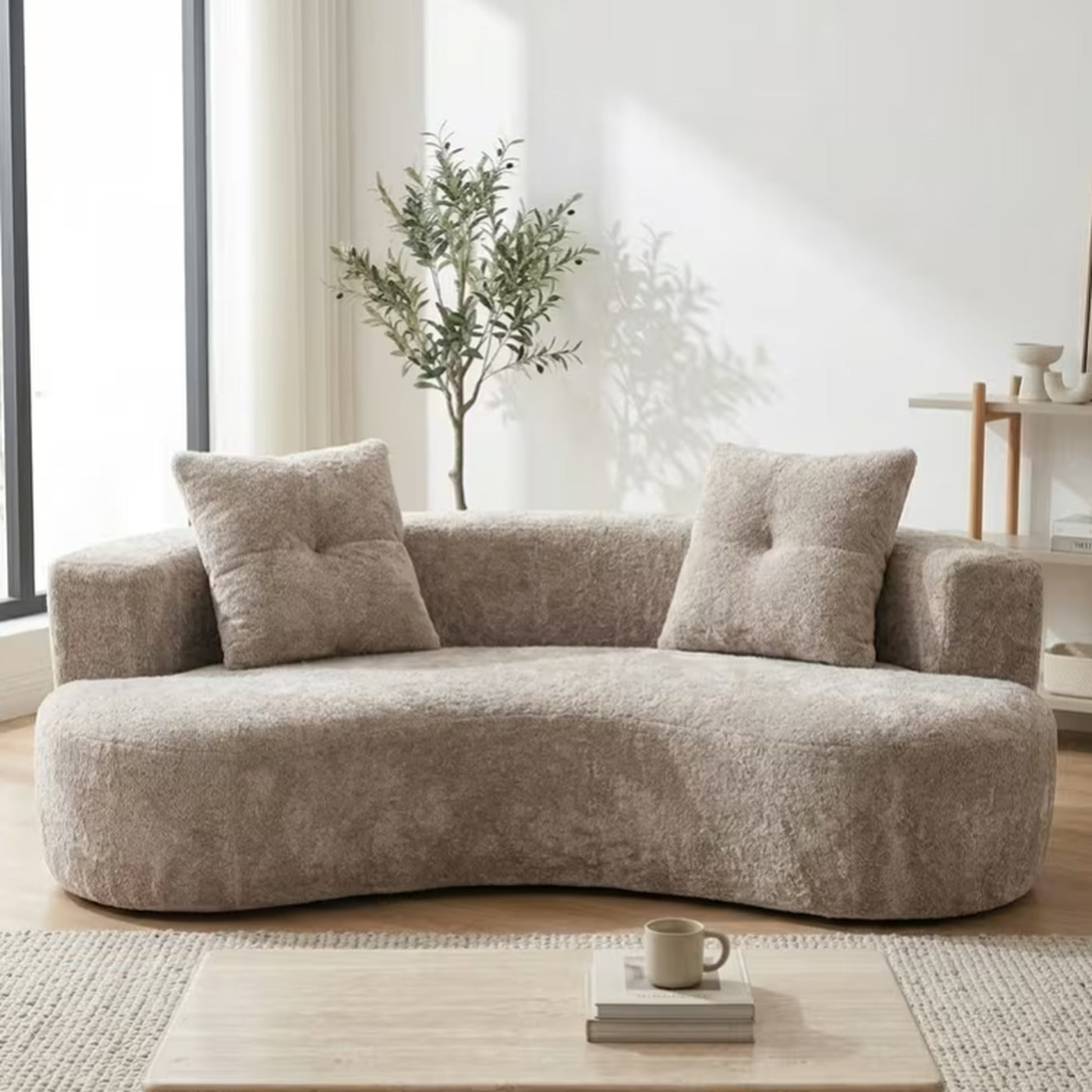 Solene curved boucle 3 seater couch in white with two matching bolster cushions in a sunlit living room